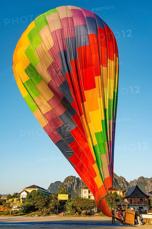 Colourful hot air balloon on ground after landing