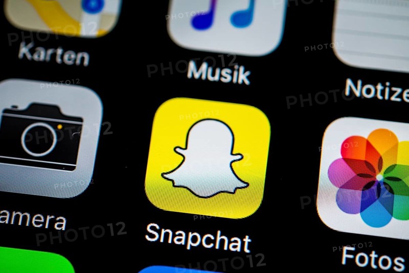 Smartphone screen display with Photos and Snapchat app icons in detail