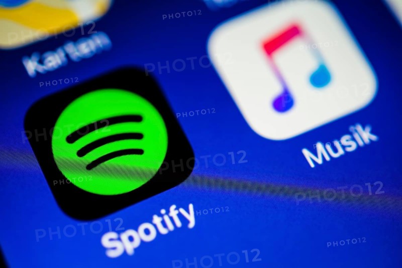 Smartphone screen with Music and Spotify app icons in detail