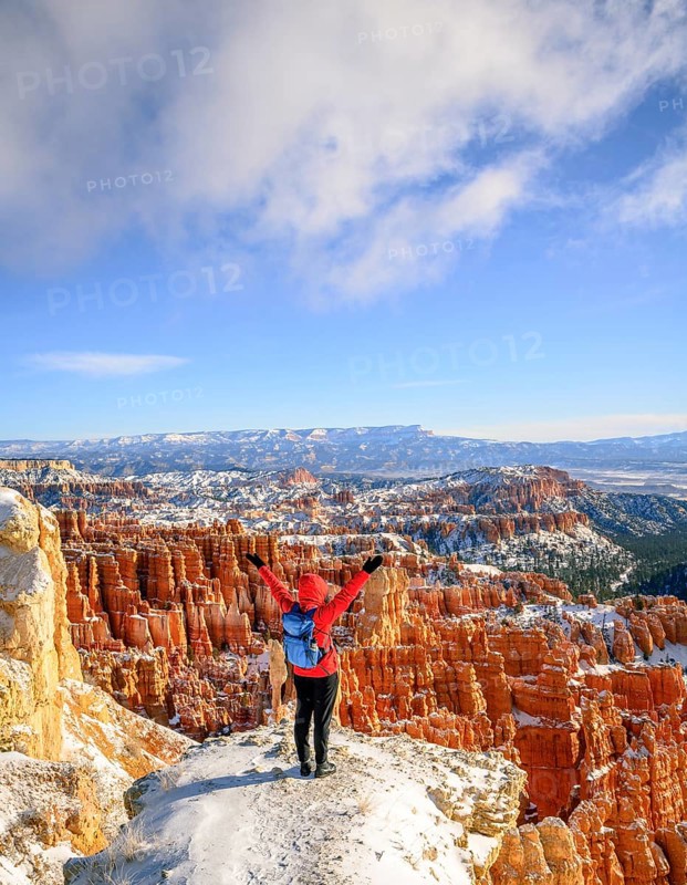 Young woman with outstretched arms overlooking the amphitheatre