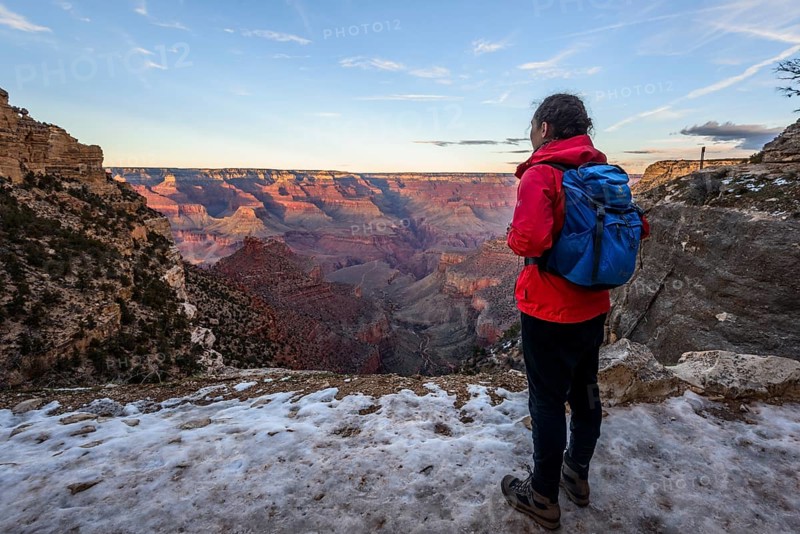 Young woman looking into the gorge of the Grand Canyon