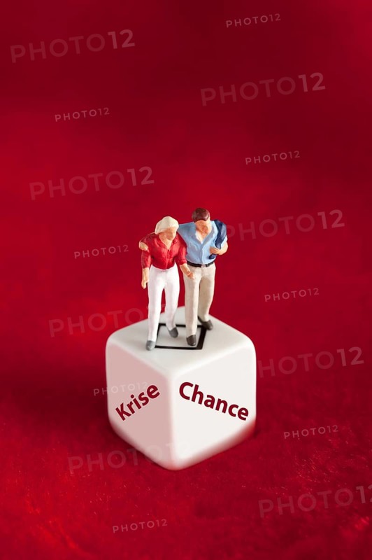 Pair of figures stands on cube with stroke crisis or chance