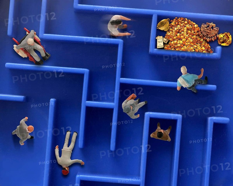 Different toy figures in a labyrinth looking for a way to the gold treasure