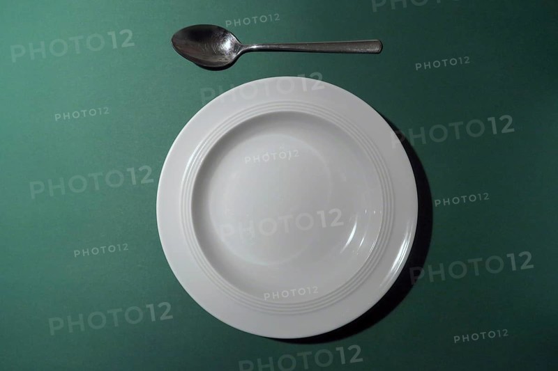 Empty white plate with spoon