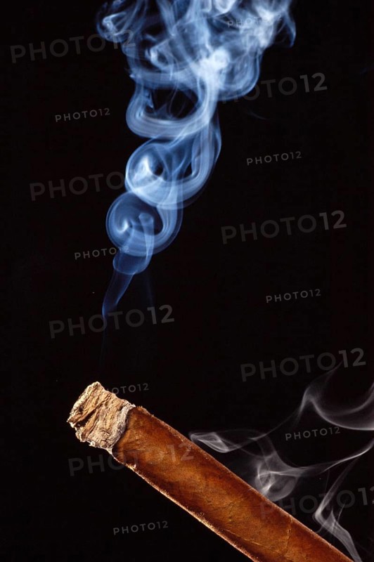 Burning cigar with cigar smoke