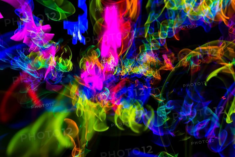 Colorful lights from glow sticks at a dark party using long exposure ight effect