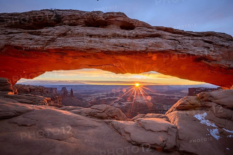 View through arch Mesa Arch at sunrise with sunstar