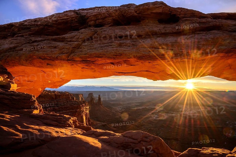 View through arch Mesa Arch at sunrise with sunstar