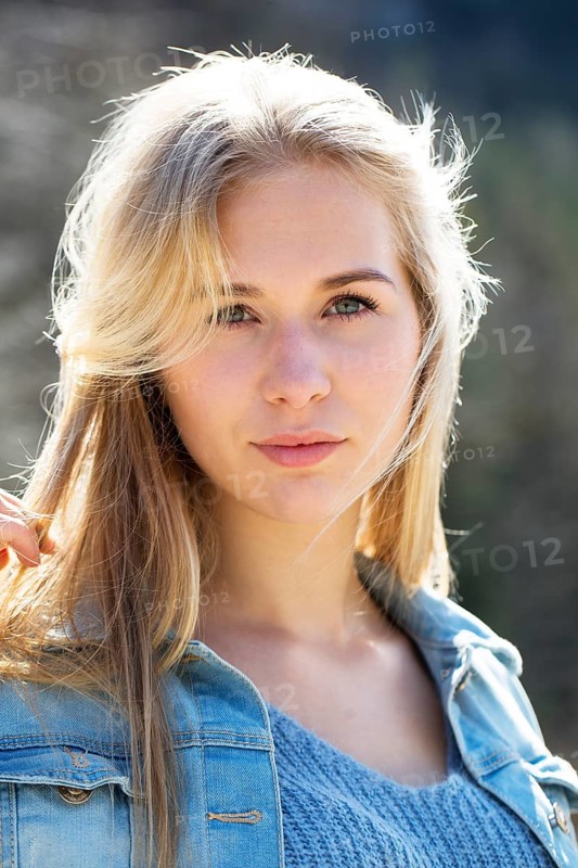 Portrait of a young woman with long blond hair