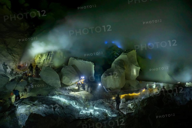 Workers in toxic sulfur mining in sulfur mine at night