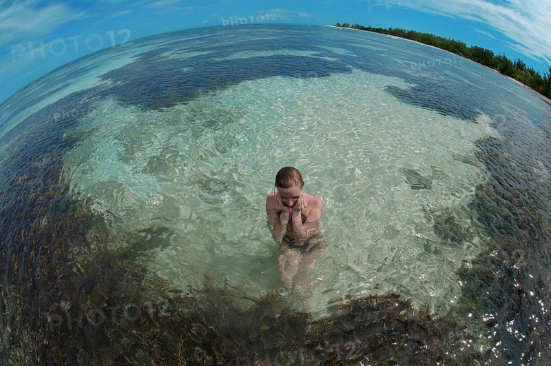 A young woman sitting in water