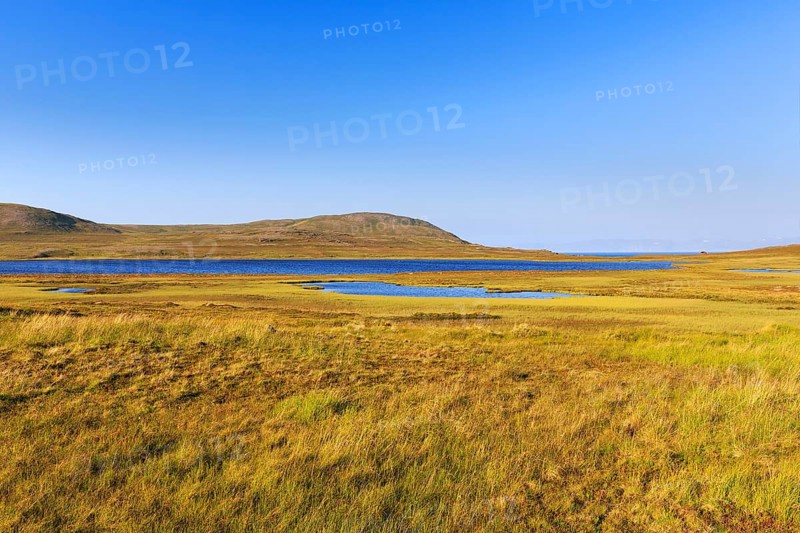 Barren landscape with meadows and glacial lakes