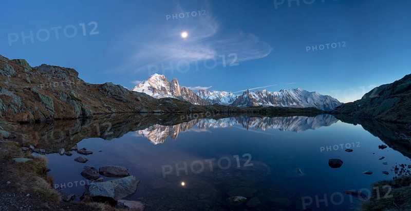 Moon and Mont Blanc reflected in the Lac des Chesery after sunset