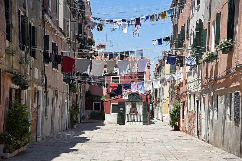 Laundry drying on clothes lines across the street