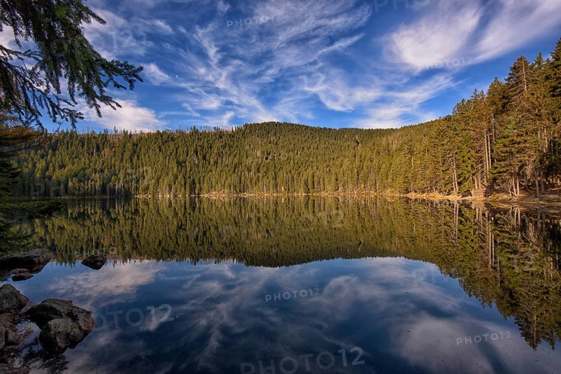 Reflection with clouds in Certovo jezero lake in fall