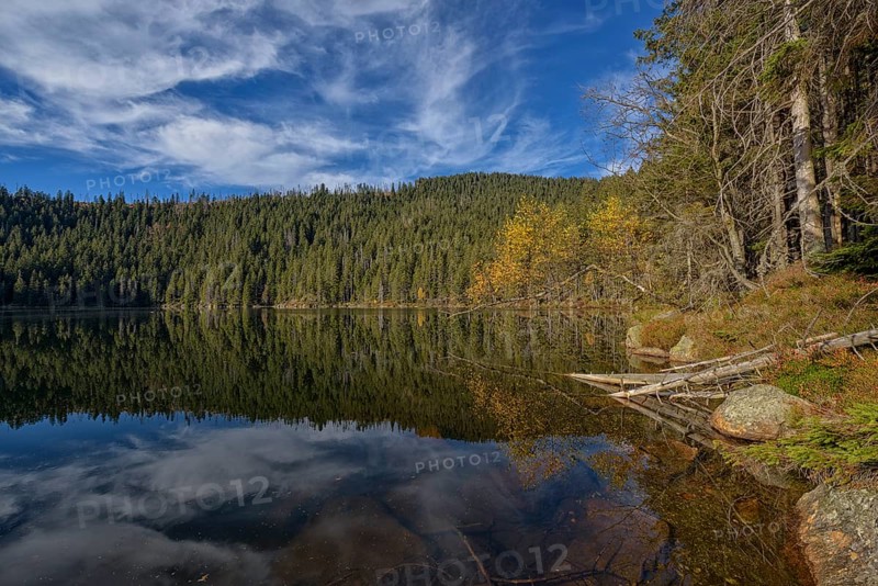 Reflection with clouds in Certovo jezero lake in fall