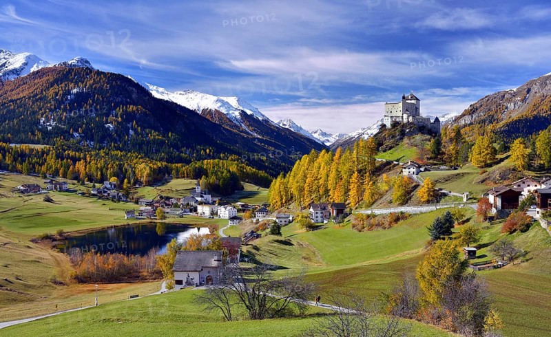Castle Tarasp and mountain village Fontana in autumn
