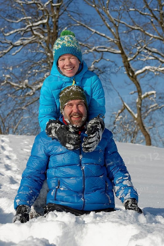 Father and son playing in the snow