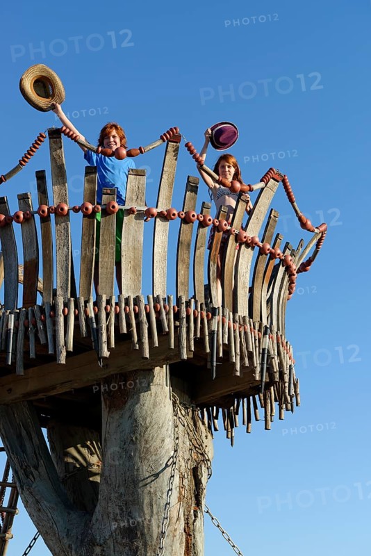 Boy and girl standing on lookout tower at Cape Kamenjak