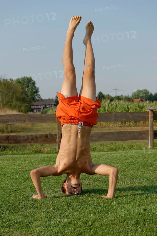 Teenage boy doing headstand