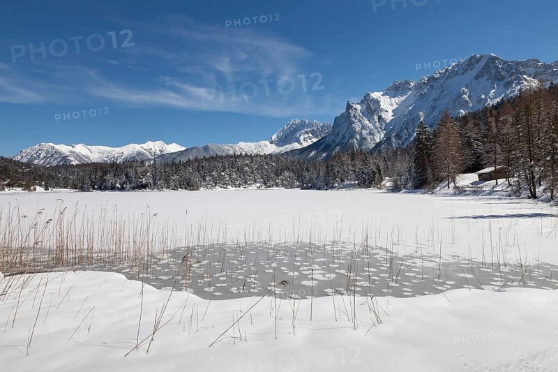Frozen lake Lautersee in front of Karwendel Mountains