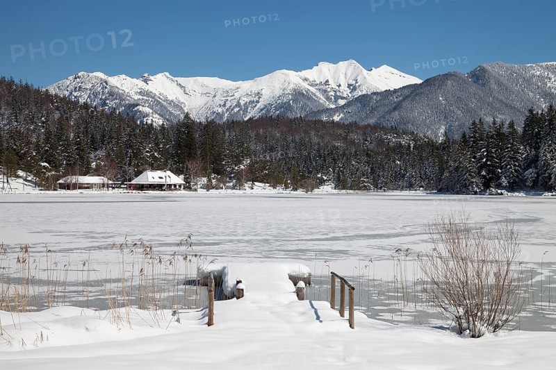 Frozen lake Lautersee in front of Karwendel Mountains
