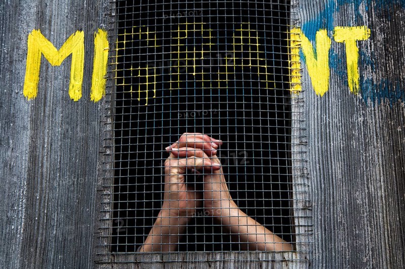 Hands behind bars