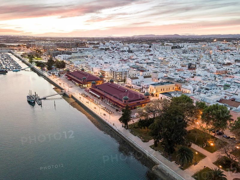 City view with two market buildings in the evening
