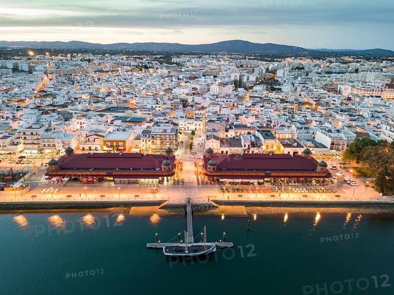 City view with two market buildings in the evening