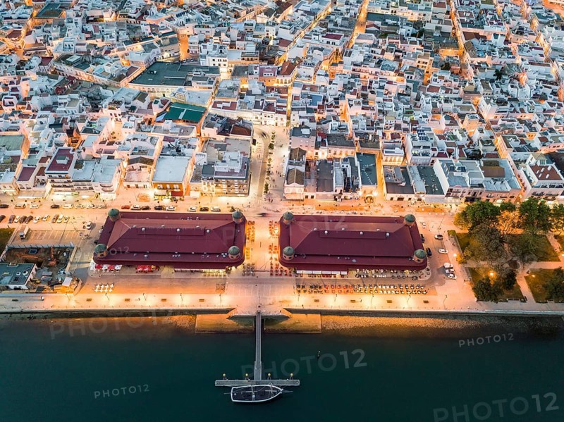 City view with two market buildings in the evening