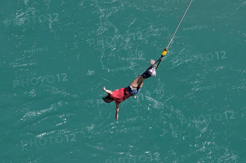Bungee jumper on the rope over Kawarau River