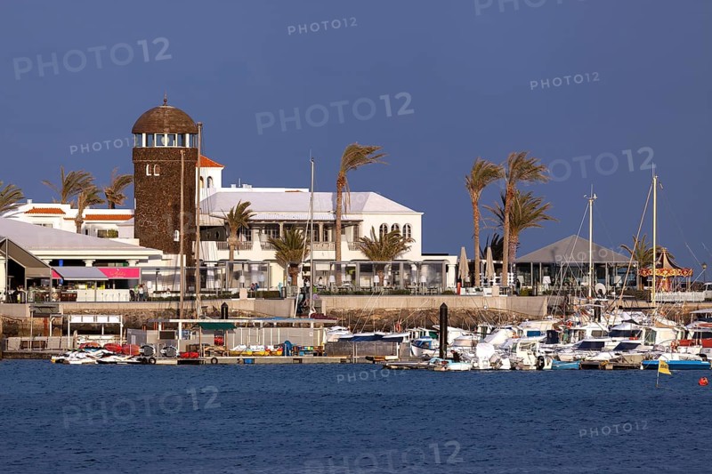 Marina and sidewalk cafe in El Castillo or Caleta de Fuste