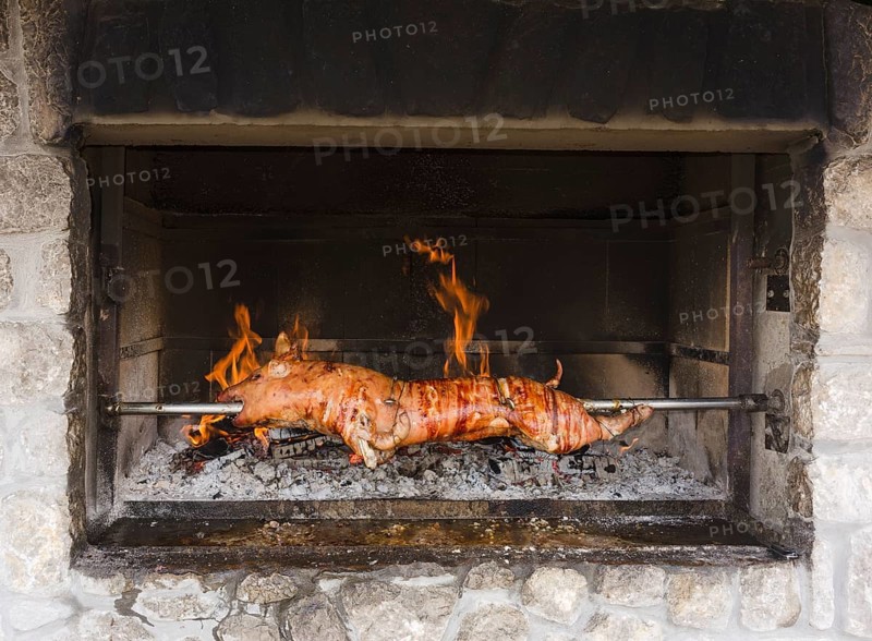 Pigling on spit over the fire