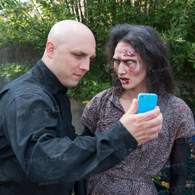 Zombie and man with smartphone