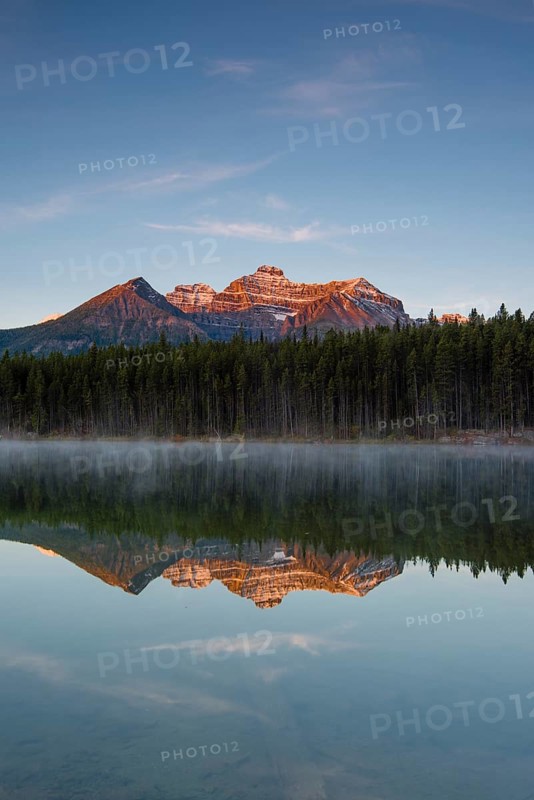 The Bow Range reflected in Herbert Lake at dawn