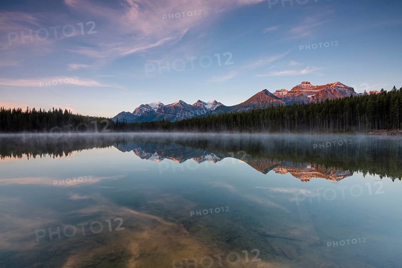 The Bow Range reflected in Herbert Lake at dawn