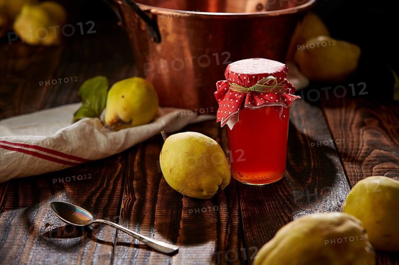 Quince jelly and fruit on wooden table