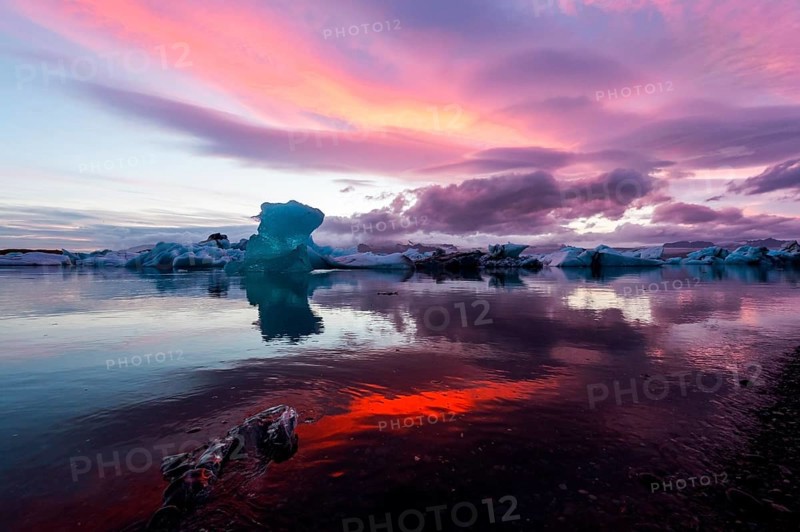 Blue iceberg in sunset