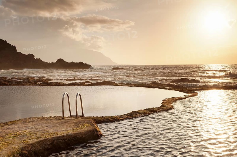 Natural swimming pool at sunset