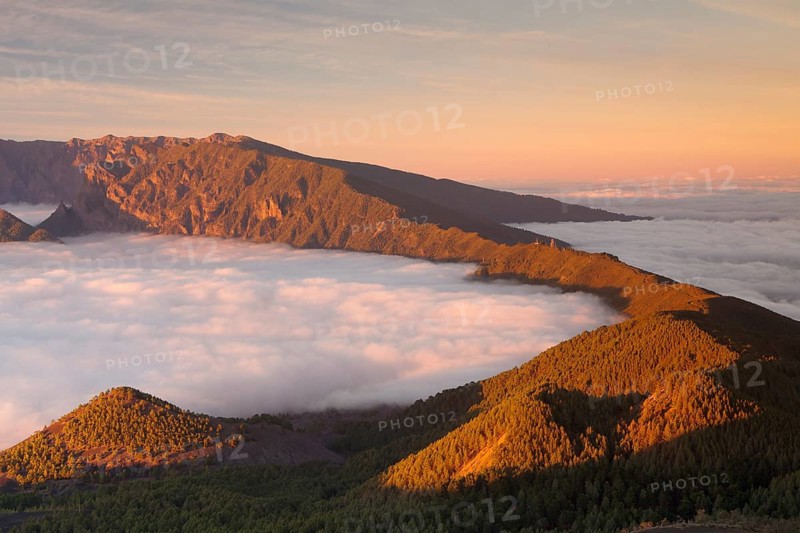 Cumbre Nueva and Cumbre Vieja mountains at sunset above clouds