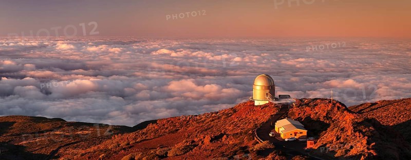 Observatory on the Roque de los Muchachos with clouds at sunset