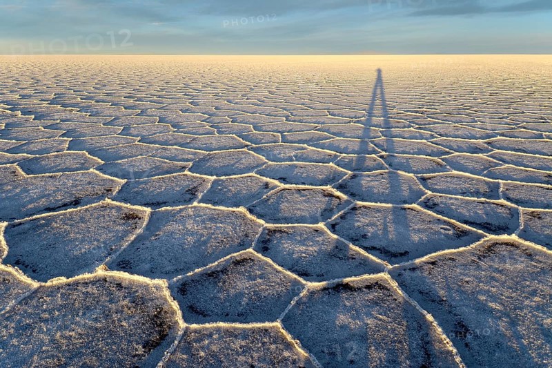 Photographer's shadow on honeycomb structure of Salar de Uyuni