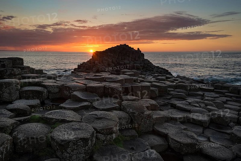 Basalt columns by the coast at sunset