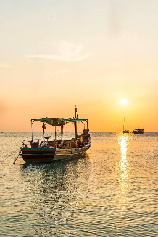 Fishing boat in the sea at sunset