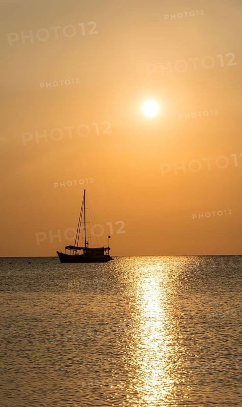 Sailboat in the sea at sunset