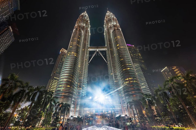 Fountain in front of the illuminated Petronas Tower at night