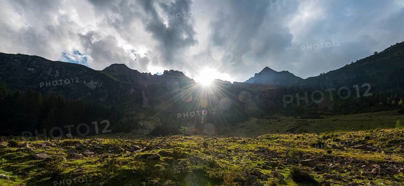 Sun shining over the mountain peak