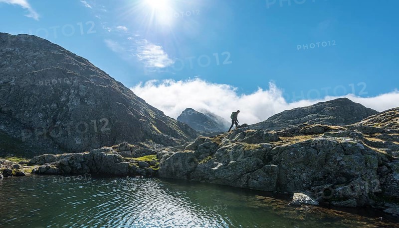 Hiker by a mountain lake