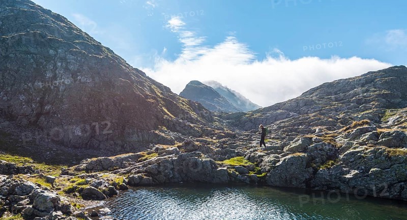 Hiker by a mountain lake