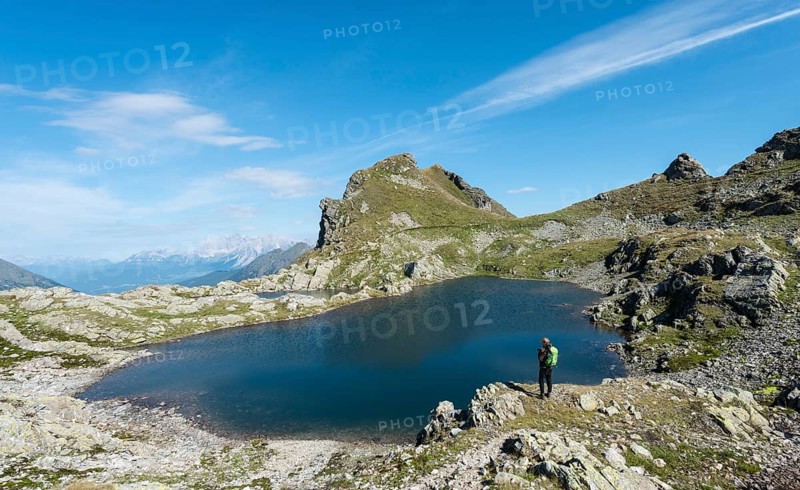 Hiker by a mountain lake